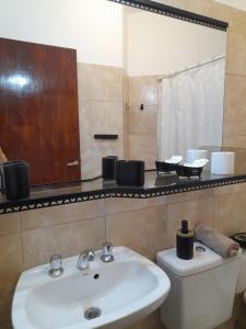 贝伦Alojamiento Belen Catamarca的一间带水槽、卫生间和镜子的浴室
