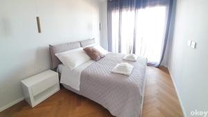 巴里Seven Seas Luxury Apartments - Bari San Girolamo的一张小床,位于带大窗户的房间里