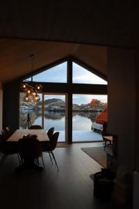 莱克内斯Visit Mortsund, Lofoten的一间带桌子和大窗户的用餐室