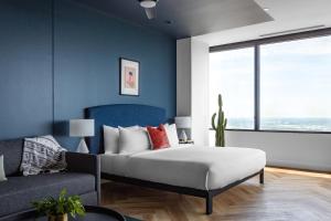达拉斯Mint House Dallas - Downtown的一间卧室配有一张特大号床和一张沙发