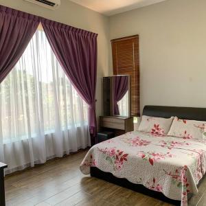 新山Santai Homestay Jb的一间卧室配有一张床,窗户配有紫色窗帘
