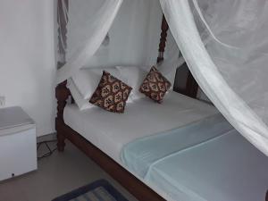 阿鲁特伽马C-Lanka Guest House的一张带两个枕头的白色床
