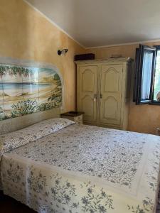 奥罗塞伊Orosei RE - Villa Samuela a 50 m dal mare的卧室配有一张床,墙上挂有绘画作品