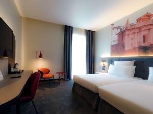 贝加莫贝加莫中心多尔斯宫美居酒店 的酒店客房配有两张床和一张书桌