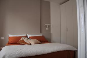 斯培西亚The Blue Nest - Red Apartment near 5 Terre的一间卧室配有带橙色和白色枕头的床