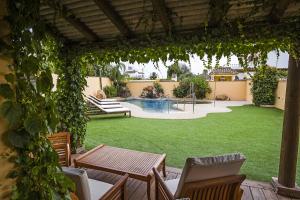 扎霍拉AROHAZ Hotel & Restaurante的一个带桌椅的庭院和一个游泳池
