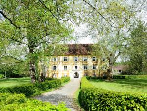德意志兰茨贝格Schloss Frauenthal的一座古老的石头房子,有一条通往房子的路径