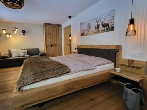 纳瑟尔文勒Landhaus Schatz的一间卧室配有一张木床和一张沙发