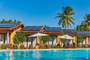 卡姆布库Almai Cumbuco的游泳池顶部设有太阳能电池板的房子