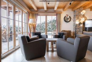 皮森多夫AvenidA Panorama Chalet by Alpin Rentals的客厅配有椅子和桌子,设有窗户