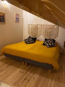 Arras-en-LavedanLe hautacam的一间卧室配有一张带黄色床单和枕头的床。