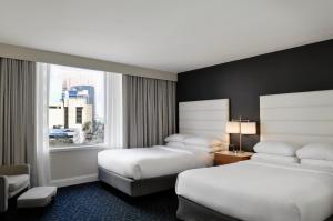 坦帕Hotel Tampa Riverwalk的酒店客房设有两张床和窗户。