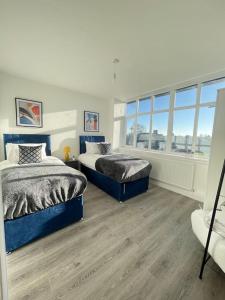 弗特威克Flitwick Luxury 3 Bedroom Apartment的一间卧室设有两张床和窗户。
