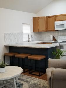 凤凰城Tiny home rentals near Ft Moore的厨房配有水槽和带凳子的台面