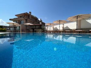 索佐波尔Villa Mia的一个带桌子和遮阳伞的大型蓝色游泳池
