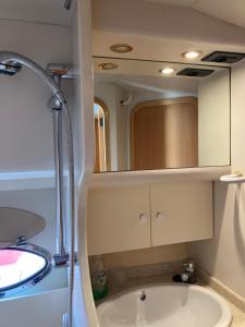 圣米格尔德阿沃纳Luxury Yacht Kamikara的浴室配有盥洗盆和带镜子的淋浴