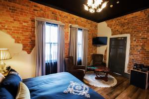伊登Hotel Australasia的一间卧室设有一张床和砖墙