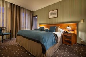 捷克利帕Hotel Morris Premium Collection的酒店客房设有一张大床和一张书桌。