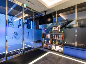 东京HOTEL LiVEMAX Akasaka的配有电视和书架的房间
