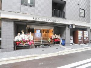 东京HOTEL LiVEMAX Tokyo Shintomicho的鲜花展示的建筑物前的商店