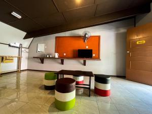 拉瑙SUNRISE RECREATION HOMESTAY & CHALET的一间房间,配有一张桌子和一些色彩缤纷的凳子