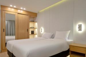 开罗Parkside Boutique Furnished Apartments的卧室设有一张白色大床和一扇窗户。