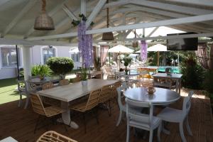 利贾Caretta - Caretta Hotel的一间带桌椅和紫色鲜花的用餐室