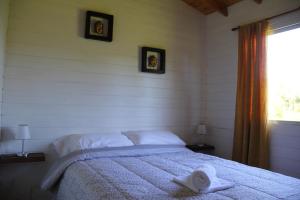 蒂格雷Cabaña El Mahayana的一间卧室配有一张床,床上有毛巾