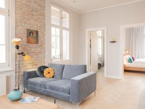 黑灵斯多夫OSTKÜSTE - Villa Groth Design Apartments的带沙发和砖墙的客厅