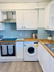 艾尔斯伯里Aylesbury Apartment for Contractors and Holidays的厨房配有洗衣机和烘干机