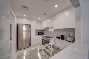 迪拜Fantastic View l 2BR l Fully Equipped的厨房配有不锈钢冰箱和水槽
