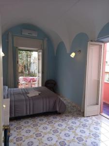 加埃塔Dimora di Enea - Gaeta Medievale的一间卧室配有一张蓝色墙壁的床