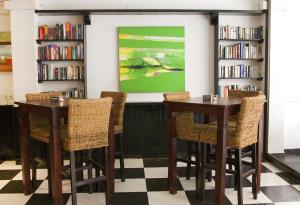 埃尔阿雷纳尔迪拉马尔旅馆的图书馆里设有2张桌子和椅子,配有书架
