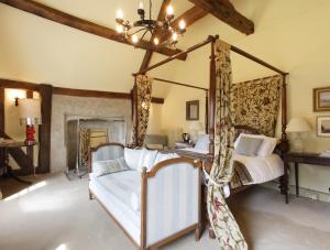 HarlingtonB&B Harlington Manor的一间卧室配有一张天蓬床和吊灯。