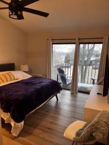 日内瓦湖Newly Remodeled Mid-Century Modern Lake Condo的一间卧室设有一张床,享有阳台的景色