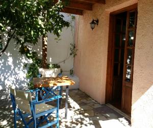 帕琉乔拉Exclusive Cottage in S West Crete in a quiet olive grove near the sea的房子前面的一张桌子和椅子