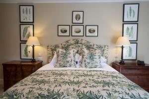瑟索The Granary Lodge Bed & Breakfast的卧室配有一张床,墙上有三幅照片