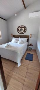 JaguaripeCasa temporada jaguaripe bahia toca do guaiamum的卧室设有一张白色大床和木地板