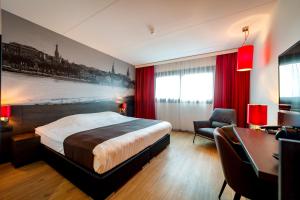 霍夫多普阿姆斯特丹机场贝斯韦斯特优质酒店的酒店客房设有一张大床和一张书桌。