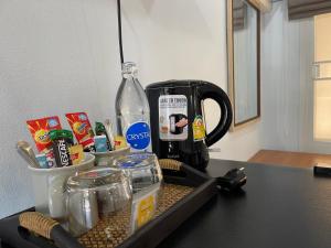 乌泰他尼府THA PAE SUNG - ท่าแพซุง的配有咖啡壶的柜台和一瓶水