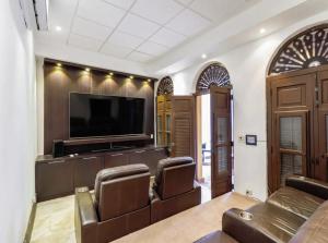 圣胡安Old San Juan Rentals的客厅配有真皮座椅和平面电视