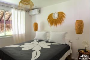 波拉波拉Villa Noa Noa - Matira的一间卧室,配有一张带鲜花的床