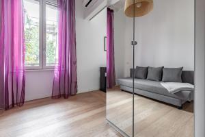 米兰Turro Cozy Apartment的客厅配有粉红色窗帘和沙发