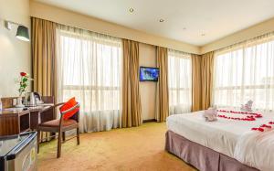内罗毕里约酒店的配有一张床和一张书桌的酒店客房