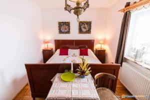 圣格奥尔基PENSIUNEA BORDÁS PANZIÓ的一间卧室配有一张床和一张桌子,上面有绿色的碗