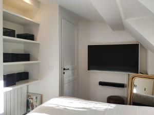 巴黎MARAIS CHIC heart of Paris, premium location !的卧室配有一张床和壁挂式平面电视。