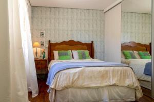 马里利亚Ótima localização a 600 m shopping Esmeralda的一间卧室配有两张绿色和白色的床
