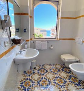 勒托阳尼席雷西雅酒店的一间带水槽和卫生间的浴室以及窗户。