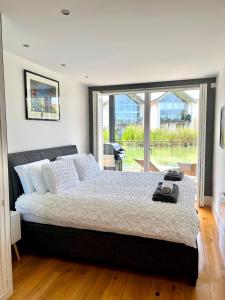 赛伦塞斯特Luxurious Lakefront Home with Pool/Spa Access的一间卧室设有一张大床和一个大窗户