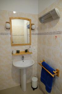 NéréAu Chiron的浴室设有水槽、镜子和蓝色毛巾